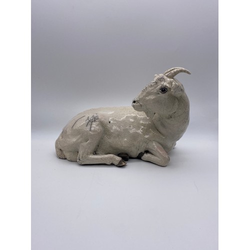 389 - POTTERY CRACKLE GLAZED RECUMBENT GOAT (EAR A/F ) AND A BLANC DE CHINE GOAT AND KID FIGURE GROUP