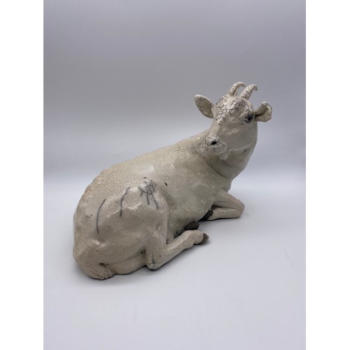 389 - POTTERY CRACKLE GLAZED RECUMBENT GOAT (EAR A/F ) AND A BLANC DE CHINE GOAT AND KID FIGURE GROUP