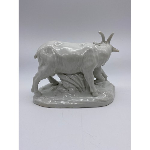 389 - POTTERY CRACKLE GLAZED RECUMBENT GOAT (EAR A/F ) AND A BLANC DE CHINE GOAT AND KID FIGURE GROUP