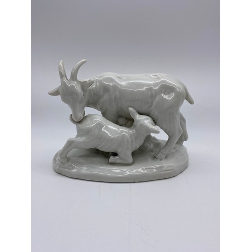 389 - POTTERY CRACKLE GLAZED RECUMBENT GOAT (EAR A/F ) AND A BLANC DE CHINE GOAT AND KID FIGURE GROUP