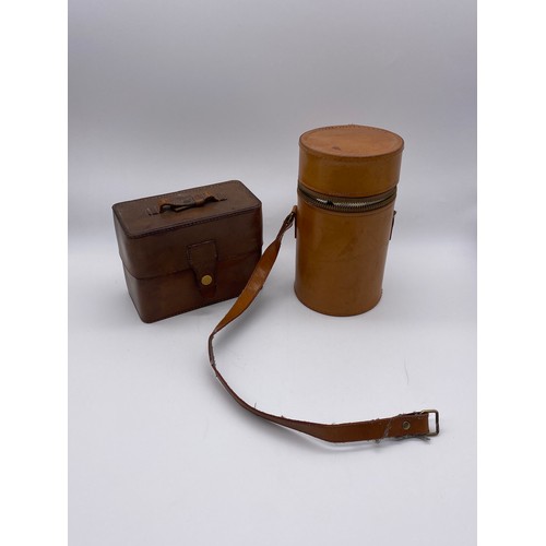 806 - LEATHER CYLINDRICAL THREE GLASS SPIRIT FLASK AND A LEATHER CASED TRAVELLING TRIPLE FLASK WITH ENAMEL... 