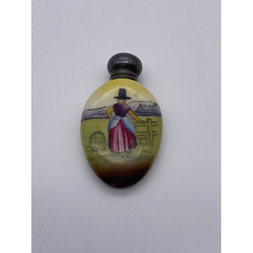 845 - SILVER TOPPED OVAL SCENT BOTTLE DECORATED WITH A LADY IN WELSH COSTUME