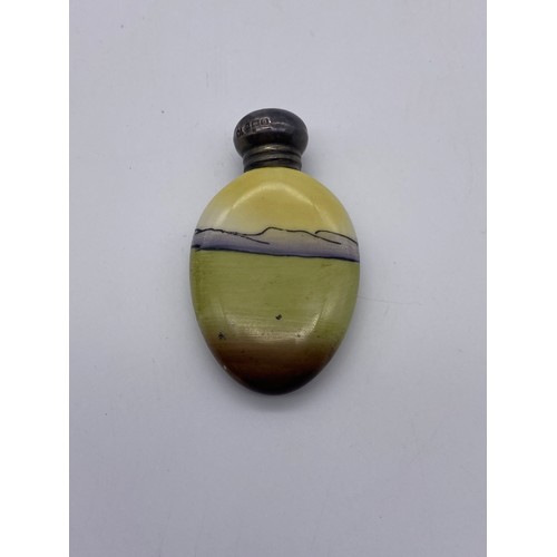 845 - SILVER TOPPED OVAL SCENT BOTTLE DECORATED WITH A LADY IN WELSH COSTUME