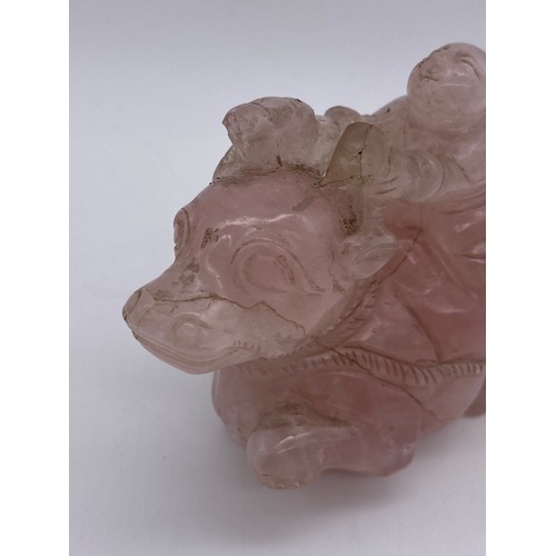 774 - CHINESE ROSE QUARTZ CARVING OF A BOY ASTRIDE A WATER BUFFALO ON STAND A/F