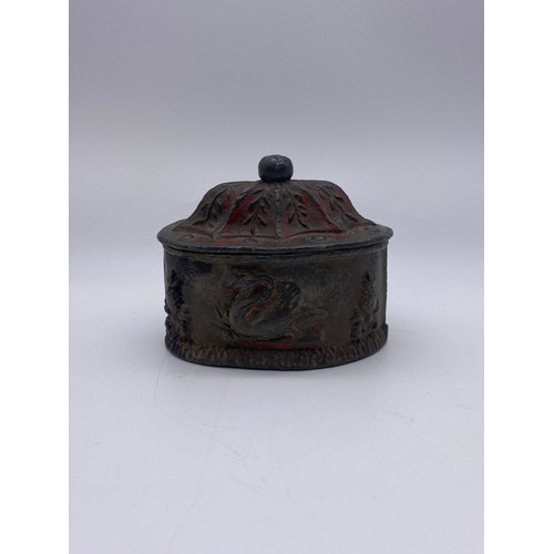 816 - HEAVY PEWTER DUTCH OVAL TOBACCO JAR AND COVER DECORATED WITH SWANS (TRACES OF ENAMEL PAINT PRESENT)