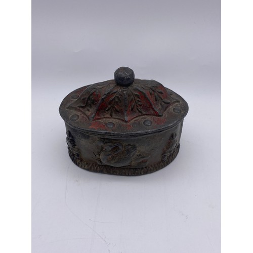 816 - HEAVY PEWTER DUTCH OVAL TOBACCO JAR AND COVER DECORATED WITH SWANS (TRACES OF ENAMEL PAINT PRESENT)