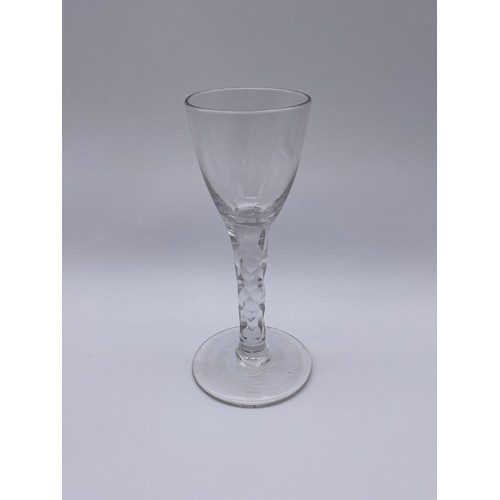 874 - TWO FACET CUT STEMMED WINE GLASSES AND A 19TH CENTURY GILT DECORATED WINE GLASS