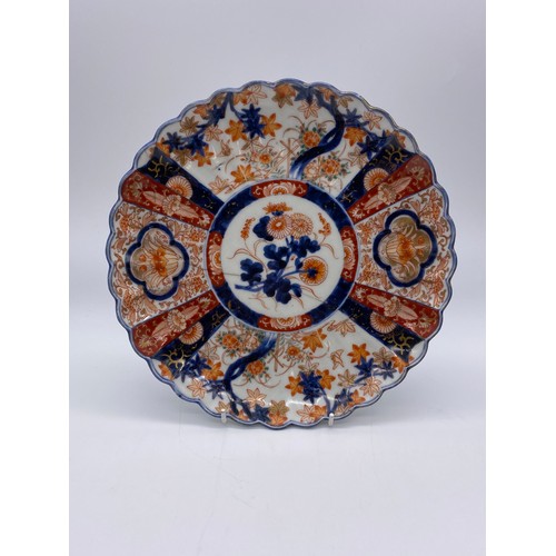 751 - TWO JAPANESE IMARI LOBED PLATES DECORATED WITH SEGMENTED PANELS AND DOUBLE DRAGON MOTIF 24cm D (one ... 