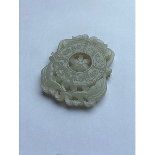 767 - QING CELADON GREEN JADE CARVED RETICULATED WHEEL PANEL