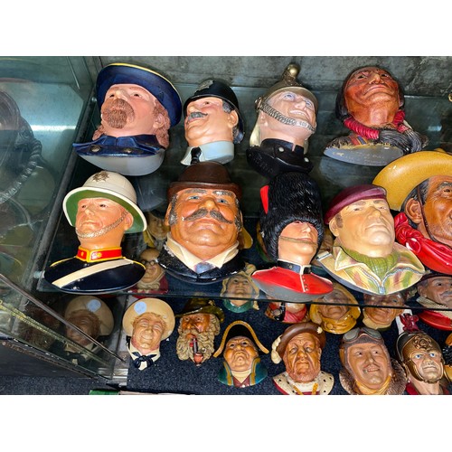 484 - TWO SHELVES OF BOSSONS CHALK FIGURE HEAD WALL PLAQUES