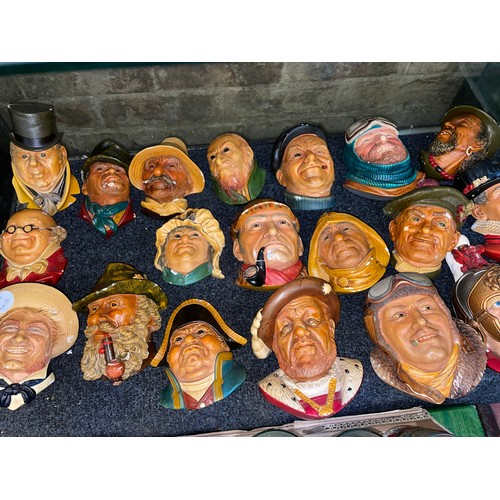 484 - TWO SHELVES OF BOSSONS CHALK FIGURE HEAD WALL PLAQUES