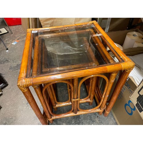 176 - NEST OF THREE BAMBOO GLASS TOP TABLES