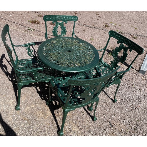 148 - GREEN PAINTED VICTORIAN STYLE CICULAR PATIO TABLE AND FOUR ELBOW CHAIRS