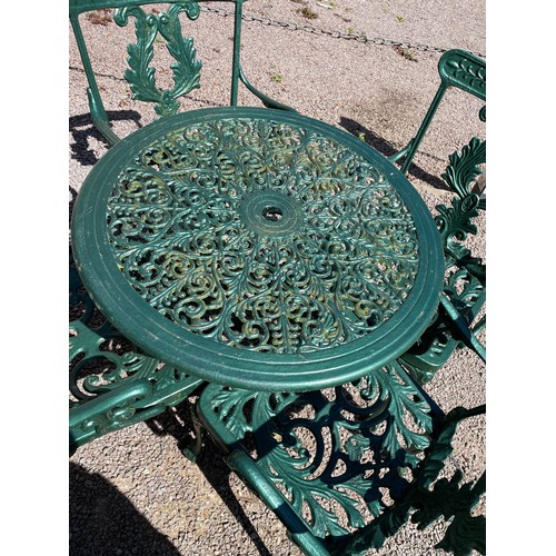 148 - GREEN PAINTED VICTORIAN STYLE CICULAR PATIO TABLE AND FOUR ELBOW CHAIRS