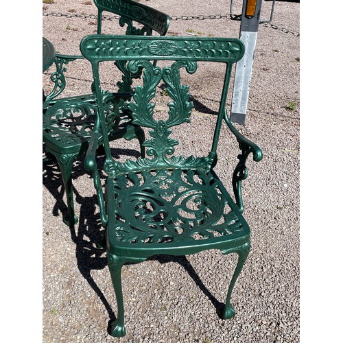 148 - GREEN PAINTED VICTORIAN STYLE CICULAR PATIO TABLE AND FOUR ELBOW CHAIRS