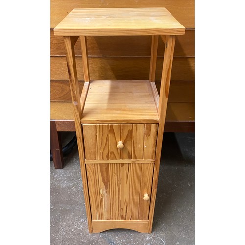 131 - PAIR OF PINE THREE DRAWER BEDSIDE CHESTS AND SMALLER PINE CUPBOARD