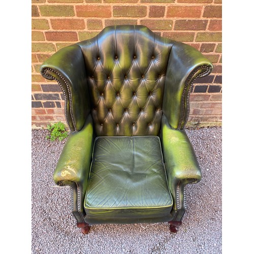 88 - BOTTLE GREEN BUTTON BACK LEATHER WING ARMCHAIR (WEAR TO ARM)