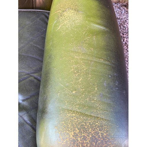 88 - BOTTLE GREEN BUTTON BACK LEATHER WING ARMCHAIR (WEAR TO ARM)