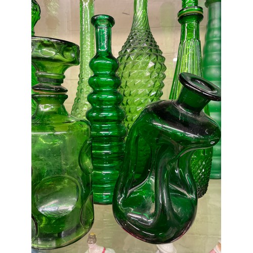 432 - SHELF OF GREEN PRESSED GLASS GENIE BOTTLES INC. EMPOLI AND A LEANING KLUK KLUK DECANTER (SOME WITH S... 