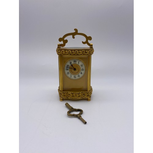 680 - QUALITY GILT ORMOLOU CHASED CASED CARRIAGE CLOCK WITH KEY