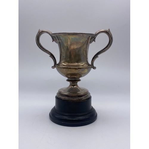 681 - LONDON SILVER GEORGIAN TWIN HANDLED TROPHY ON A GARRARD AND CO EBONISED SOCLE 9.8OZ APPROX