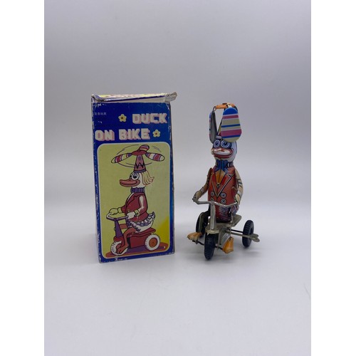 685 - BOXED TIN PLATE KEY WIND DUCK ON BIKE  NOVELTY TOY