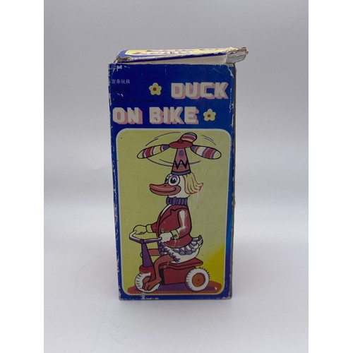 685 - BOXED TIN PLATE KEY WIND DUCK ON BIKE  NOVELTY TOY