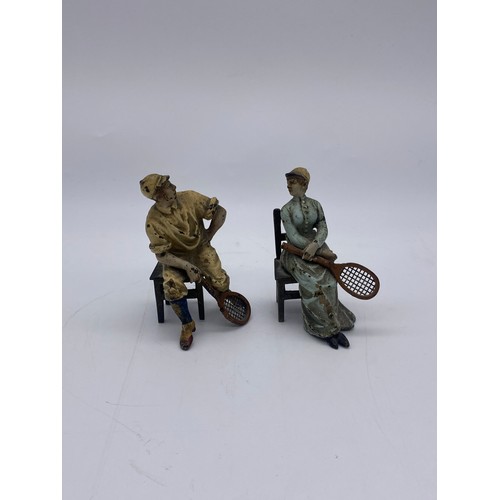 721 - TWO COLD PAINTED METAL FIGURES OF SEATED EDWARDIAN TENNIS PLAYERS