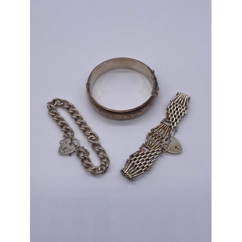 536 - SILVER ENGRAVED CUFF BANGLE WITH SAFETY CHAIN, LARGE BELCHER LINK BRACELET AND A SIX BAR GATE BRACEL... 