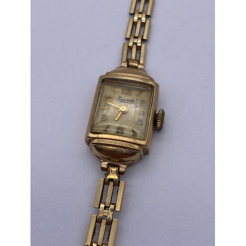 527 - LADIES EVERITE 9CT GOLD CASED WRISTWATCH ON THREE STRAND PLATED BRACELET STRAP