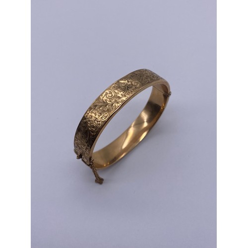 556 - 9CT GOLD ENGRAVED CUFF BANGLE WITH SAFETY CHAIN 14.2G APPROX