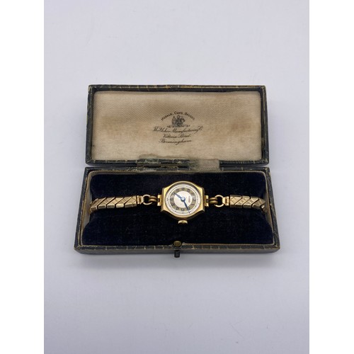 629 - LADIES 9CT GOLD CASED VISIBLE WRIST WATCH ON ELASTICATED GOLD CORE BRACELET STRAP