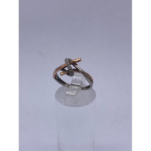 593 - 9CT WHITE AND ROSEGOLD CROSS OVER RING SIZE K 1.5G APPROX