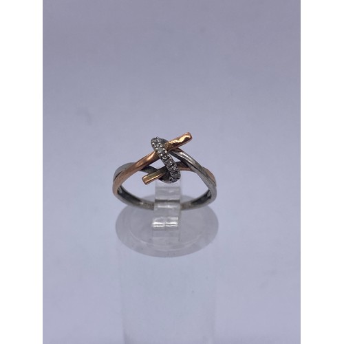 593 - 9CT WHITE AND ROSEGOLD CROSS OVER RING SIZE K 1.5G APPROX