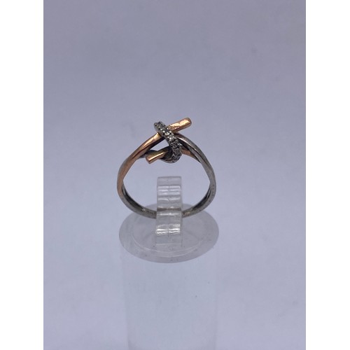 593 - 9CT WHITE AND ROSEGOLD CROSS OVER RING SIZE K 1.5G APPROX