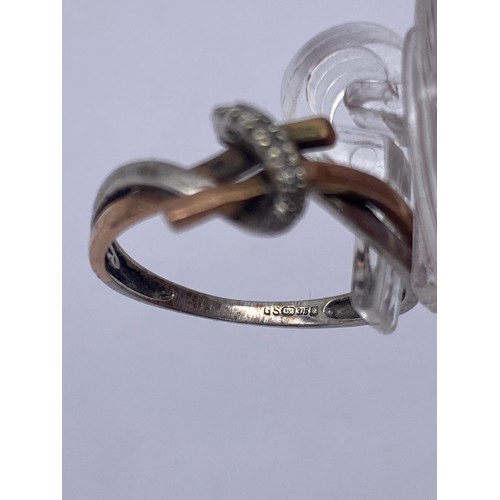 593 - 9CT WHITE AND ROSEGOLD CROSS OVER RING SIZE K 1.5G APPROX