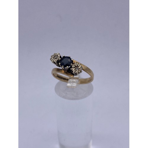 591A - 9CT GOLD SAPPHIRE AND DIAMOND CHIP CROSSOVER RING SIZE O 3.4G APPROX