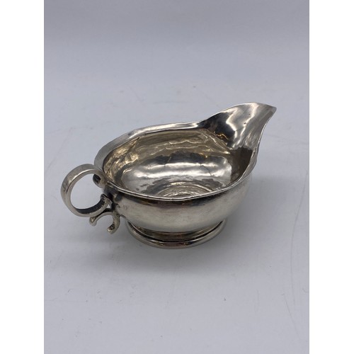 644 - SMALL UNMARKED WHITE METAL COIN JUG 1.4OZ APPROX