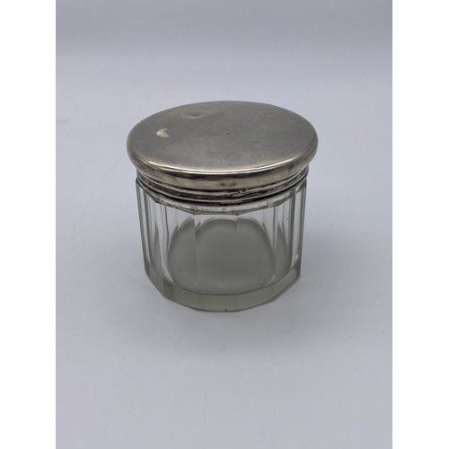 647 - THREE SILVER TOPPED AND GLASS DRESSING TABLE JARS