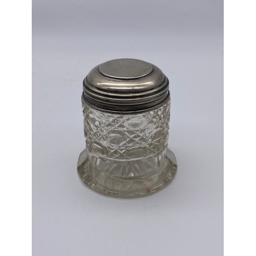 647 - THREE SILVER TOPPED AND GLASS DRESSING TABLE JARS