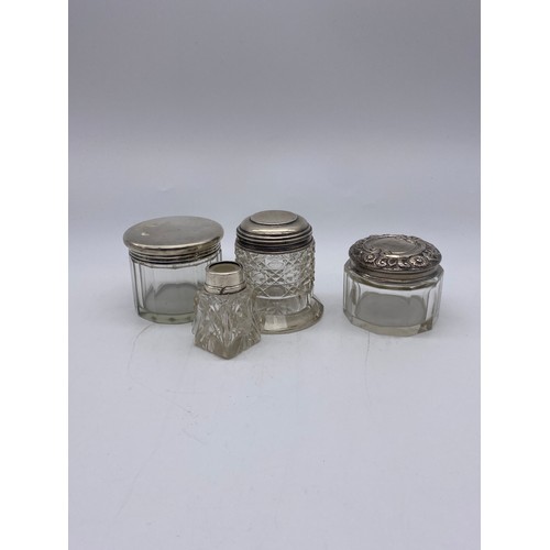 647 - THREE SILVER TOPPED AND GLASS DRESSING TABLE JARS