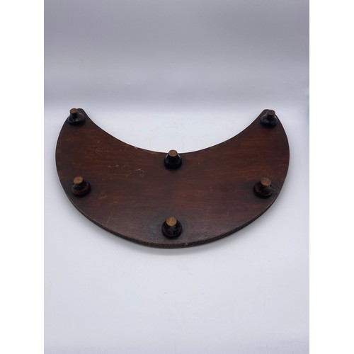 659 - CRESCENT SHAPED POKER WORK TRIVET