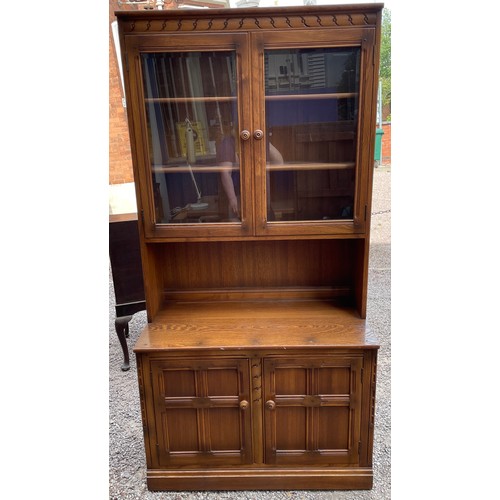 99 - ERCOL ELM GLAZED CABINET