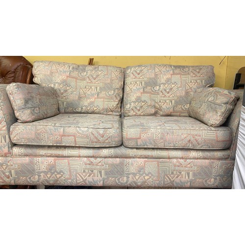 24 - PAIR OF PASTEL ABSRACT PATTERN TWO SEATER SOFAS