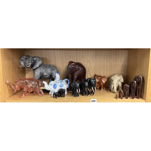 235 - SHELF OF CARVED AND PORCELAIN ELEPHANT FIGURES