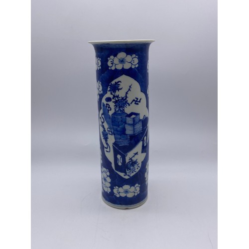 538 - CHINESE BLUE AND WHITE PRUNUS SLEEVE VASE WITH PANELS ADORNED WITH ATTRIBUTES