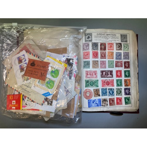 590 - WORLD STAMP ALBUM VICTORIA ONWARDS, PLUS BAG OF FRANKED POSTAGE STAMPS