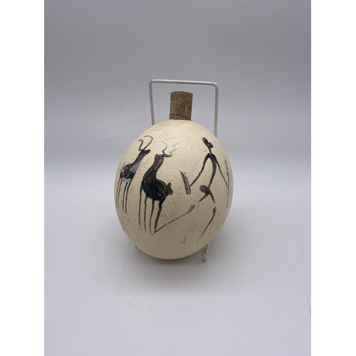 557 - OSTRICH EGG PAINTED WITH FIGURES AND ANIMALS