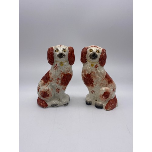 252 - STAFFORDSHIRE RECUMBENT WHIPPET INKWELL A/F AND PAIR OF SEATED SPANIELS