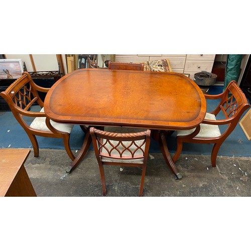 52 - YEW CROSS BANDED EXTENDING DINING TABLE AND SIX CHAIRS